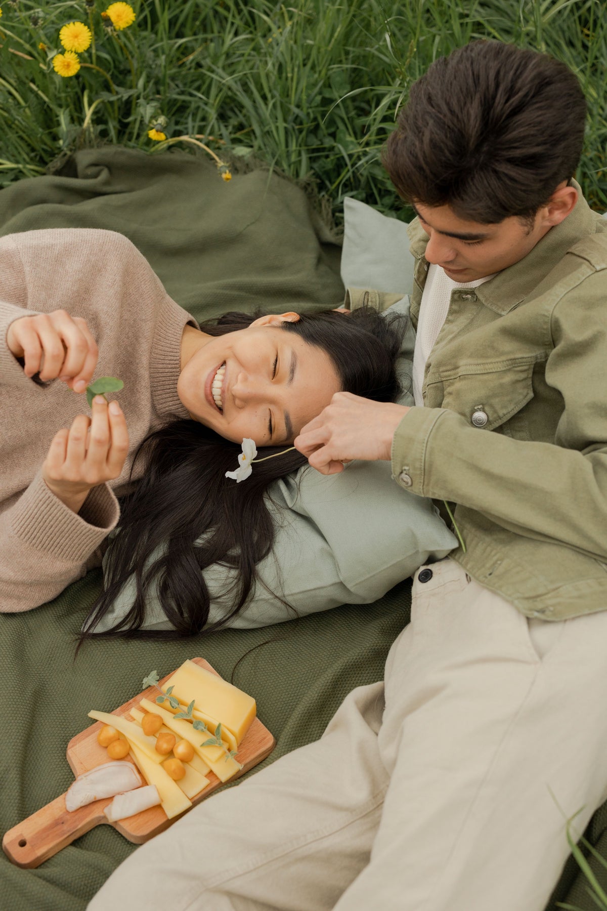 Woman and man wearing Earth & Iman linen pieces in warm daylight